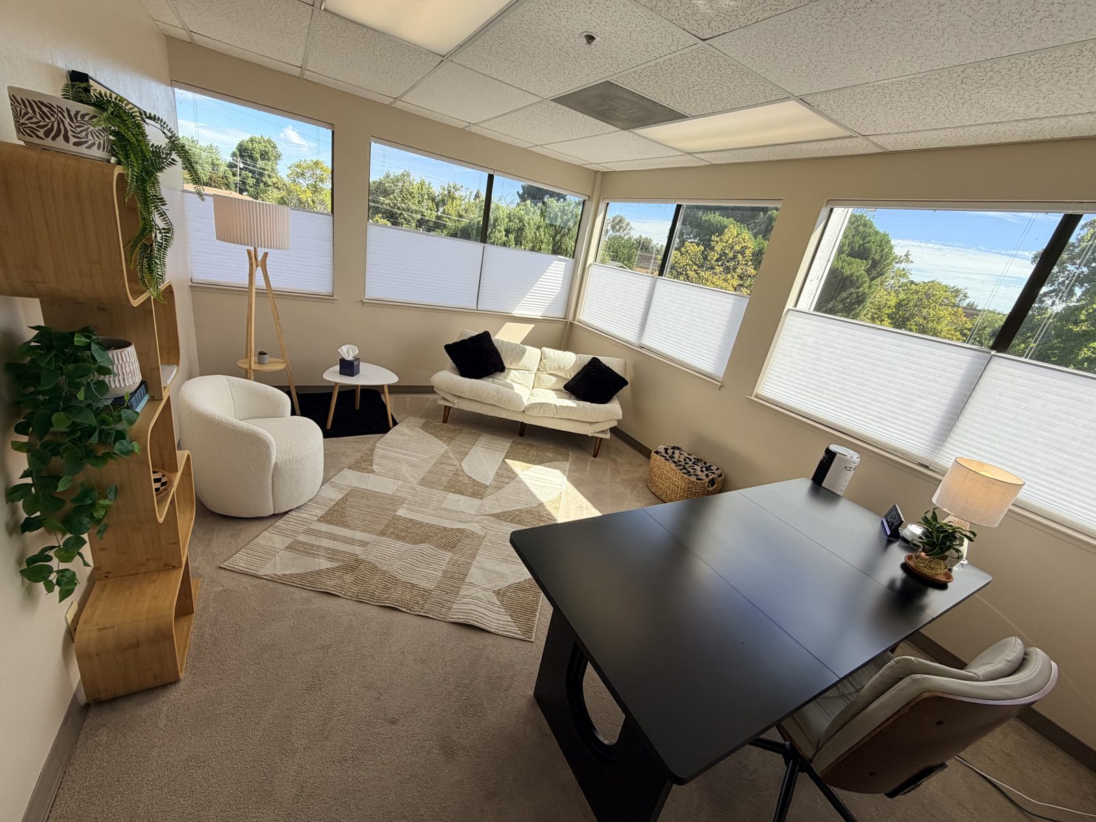 FocusRooms Room 5 — bright therapy room with couch, chairs and desk